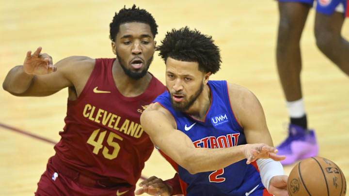 Jan 31, 2024; Cleveland, Ohio, USA; Detroit Pistons guard Cade Cunningham (2) throws a pass beside Cleveland Cavaliers guard Donovan Mitchell (45) in the fourth quarter at Rocket Mortgage FieldHouse. Mandatory Credit: David Richard-Imagn Images