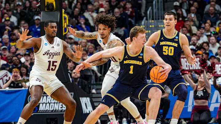 Michigan Wolverines center Danny Wolf (1) dribbles the ball into positions against Texas A&M Aggies forward Andersson Garcia (11) during the first half of the second round of the NCAA tournament at Ball Arena in Denver, Colorado, Saturday. March 22, 2025.
