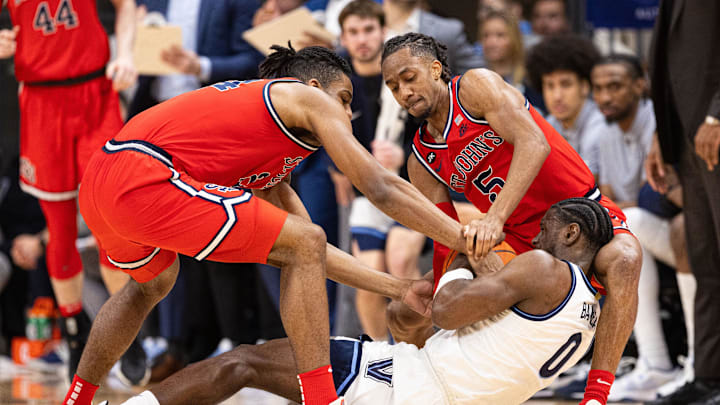 Jan 6, 2024; Villanova, Pennsylvania, USA; Villanova Wildcats guard TJ Bamba (0) and St. John's Red Storm forward Zuby Ejiofor (24) and guard Daniss Jenkins (5) wrestle for ball control during the first half at William B. Finneran Pavilion. Jan 6, 2024; Villanova, Pennsylvania, USA; Villanova Wildcats guard TJ Bamba (0) and St. John's Red Storm forward Zuby Ejiofor (24) and guard Daniss Jenkins (5) wrestle for ball control during the first half at William B. Finneran Pavilion.