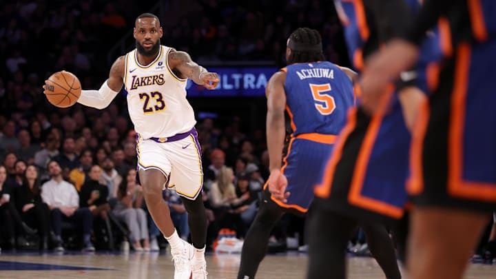 Feb 3, 2024; New York, New York, USA; Los Angeles Lakers forward LeBron James (23) brings the ball up court against New York Knicks forward Precious Achiuwa (5) during the second quarter at Madison Square Garden. Mandatory Credit: Brad Penner-Imagn Images
