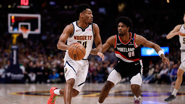 Feb 10, 2025; Denver, Colorado, USA; Denver Nuggets guard Jalen Pickett (24) controls the ball as Portland Trail Blazers guard Scoot Henderson (00) guards in the third quarter at Ball Arena. Mandatory Credit: Isaiah J. Downing-Imagn Images