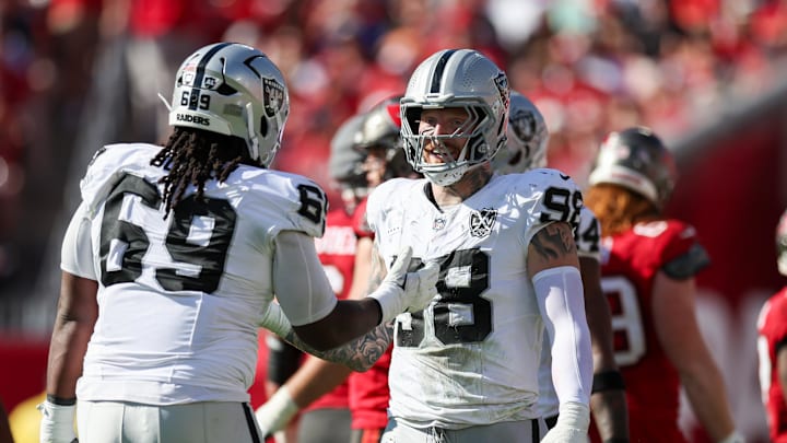 Dec 8, 2024; Tampa, Florida, USA; Las Vegas Raiders defensive end Maxx Crosby (98) and defensive tackle Adam Butler (69) reacts after a play against the Tampa Bay Buccaneers in the second quarter at Raymond James Stadium. Mandatory Credit: Nathan Ray Seebeck-Imagn Images
