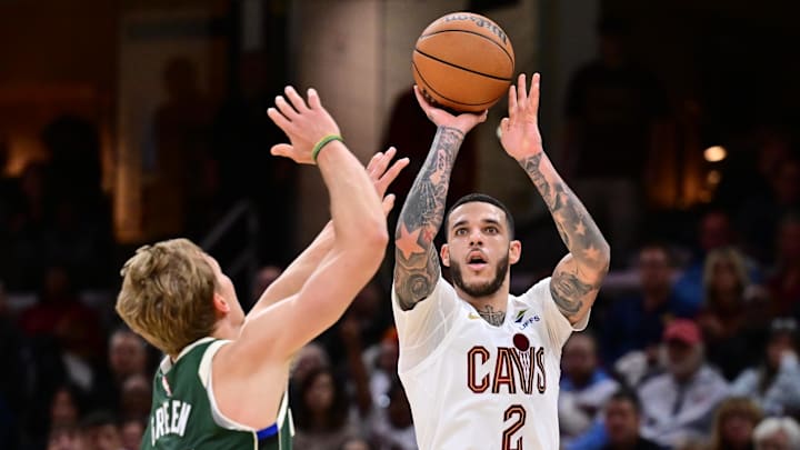 Oct 26, 2025; Cleveland, Ohio, USA; Cleveland Cavaliers guard Lonzo Ball (2) shoots over the defense of  Milwaukee Bucks guard AJ Green (20) during the second half at Rocket Arena. Mandatory Credit: Ken Blaze-Imagn Images