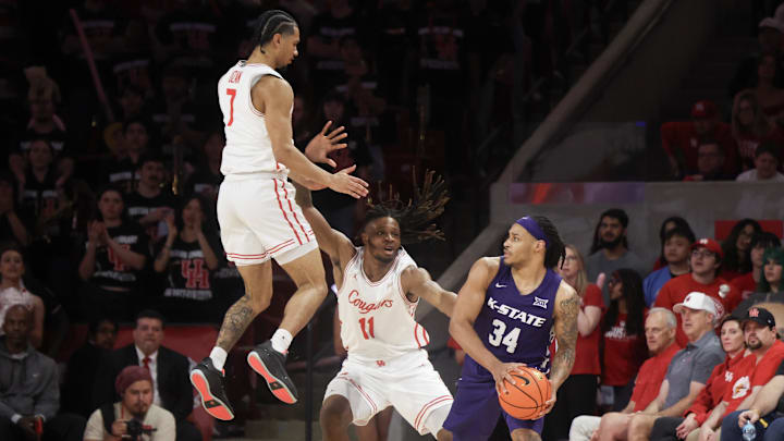 Feb 14, 2026; Houston, Texas, USA;  Kansas State Wildcats guard Nate Johnson (34) is guarded by Houston Cougars forward Joseph Tugler (11) and guard Milos Uzan (7) in the second half at Fertitta Center. Mandatory Credit: Thomas Shea-Imagn Images