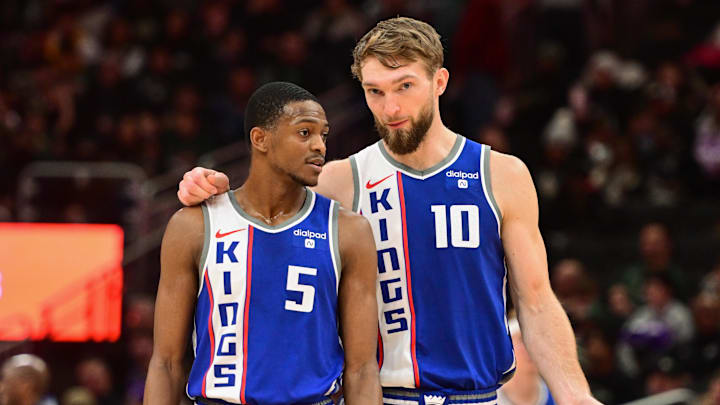 Jan 14, 2024; Milwaukee, Wisconsin, USA;  Sacramento Kings guard De'Aaron Fox (5) and center Domantas Sabonis (10) talk during a timeout in the third quarter against the Milwaukee Bucks at Fiserv Forum. Mandatory Credit: Benny Sieu-Imagn Images