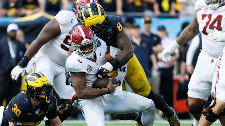 Dec 31, 2024; Tampa, FL, USA; Michigan Wolverines defensive end Derrick Moore (8) sacks Alabama Crimson Tide quarterback Jalen Milroe (4) during the first half at Raymond James Stadium. Mandatory Credit: Matt Pendleton-Imagn Images