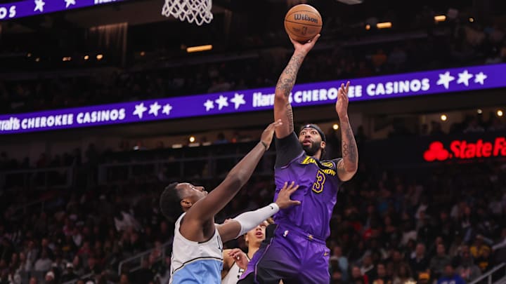Dec 6, 2024; Atlanta, Georgia, USA; Los Angeles Lakers center Anthony Davis (3) shoots over Atlanta Hawks forward Onyeka Okongwu (17) in the second quarter at State Farm Arena. Mandatory Credit: Brett Davis-Imagn Images