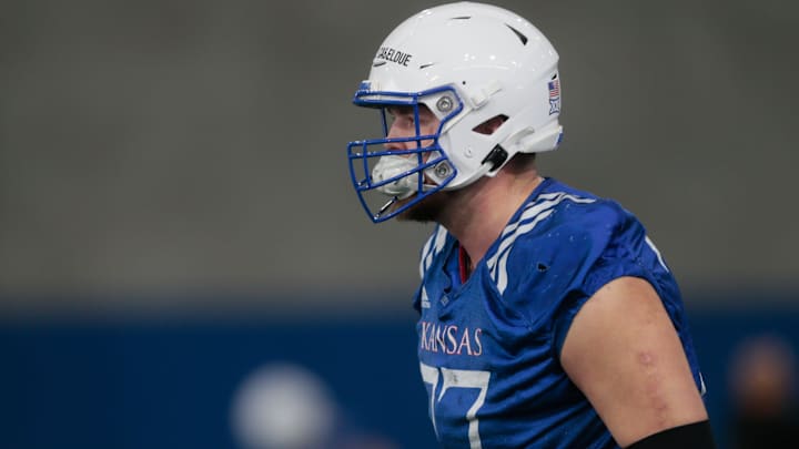 Kansas junior offensive lineman Bryce Cabeldue (77) warms up with the team during practice Tuesday at the Kansas Indoor Practice Facility. Kansas junior offensive lineman Bryce Cabeldue (77) warms up with the team during practice Tuesday at the Kansas Indoor Practice Facility.