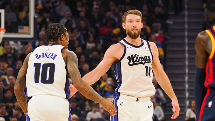 Jan 5, 2025; San Francisco, California, USA; Sacramento Kings center Domantas Sabonis (11) high fives forward/guard DeMar DeRozan (10) after scoring a basket against the Golden State Warriors during the second quarter at Chase Center. Mandatory Credit: Kelley L Cox-Imagn Images