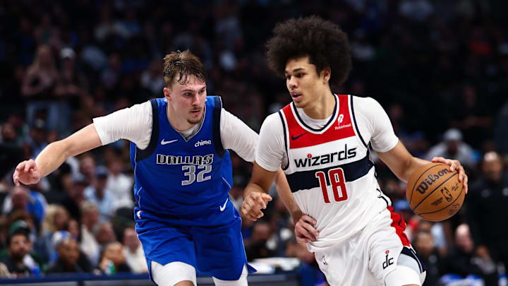 Oct 24, 2025; Dallas, Texas, USA;  Washington Wizards forward Kyshawn George (18) drives to the basket as Dallas Mavericks forward Cooper Flagg (32) defends during the second half at American Airlines Center. Mandatory Credit: Kevin Jairaj-Imagn Images