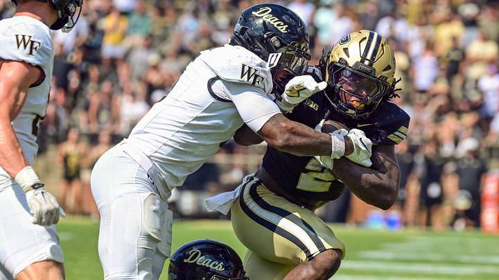 Sep 12, 2026; West Lafayette, Indiana, USA;  Purdue Boilermakers running back Fame Ijeboi (2) is tackled by Wake Forest Demon Deacons defensive back Davaughn Patterson (5) during the second half at Ross-Ade Stadium.  Mandatory Credit: Marc Lebryk-Imagn Images