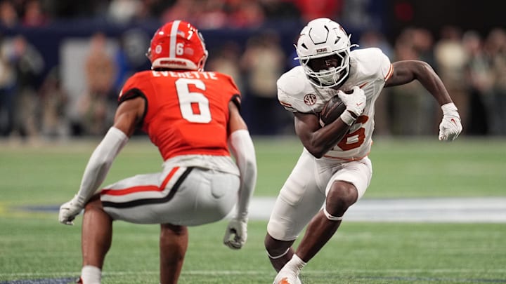 Dec 7, 2024; Atlanta, GA, USA; Texas Longhorns running back Quintrevion Wisner (26) rushes the ball against Georgia Bulldogs defensive back Daylen Everette (6) during the first half in the 2024 SEC Championship game at Mercedes-Benz Stadium. Mandatory Credit: Dale Zanine-Imagn Images Dec 7, 2024; Atlanta, GA, USA; Texas Longhorns running back Quintrevion Wisner (26) rushes the ball against Georgia Bulldogs defensive back Daylen Everette (6) during the first half in the 2024 SEC Championship game at Mercedes-Benz Stadium. Mandatory Credit: Dale Zanine-Imagn Images