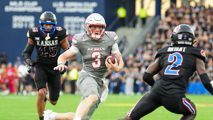 UNLV Rebels quarterback Matthew Sluka (3) runs the ball against Kansas Jayhawks defensive end Dean Miller (45) and cornerback Cobee Bryant (2) during the first half at Children's Mercy Park.