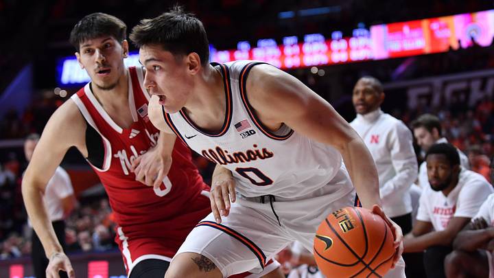 Dec 13, 2025; Champaign, Illinois, USA; Illinois Fighting Illini forward David Mirkovic (0) drives the ball past Nebraska Cornhuskers forward Berke Buyuktuncel (9) during the first half at State Farm Center. Mandatory Credit: Ron Johnson-Imagn Images Dec 13, 2025; Champaign, Illinois, USA; Illinois Fighting Illini forward David Mirkovic (0) drives the ball past Nebraska Cornhuskers forward Berke Buyuktuncel (9) during the first half at State Farm Center. Mandatory Credit: Ron Johnson-Imagn Images