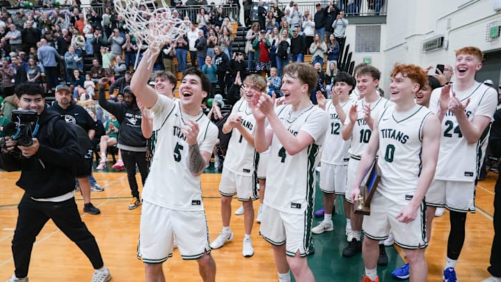 The West Salem boys basketball team celebrates winning the Central Valley Conference title.