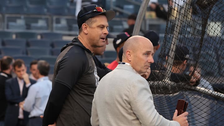Oct 11, 2022; Bronx, New York, USA; New York Yankees manager Aaron Boone, left, and general manager Brian Cashman watch batting practice before game one of the ALDS against the Cleveland Guardians for the 2022 MLB Playoffs at Yankee Stadium. Mandatory Credit: Vincent Carchietta-Imagn Images
