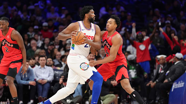 Feb 11, 2025; Philadelphia, Pennsylvania, USA; Philadelphia 76ers center Joel Embiid (21) drives against Toronto Raptors forward Scottie Barnes (4) in the fourth quarter at Wells Fargo Center. Mandatory Credit: Kyle Ross-Imagn Images
