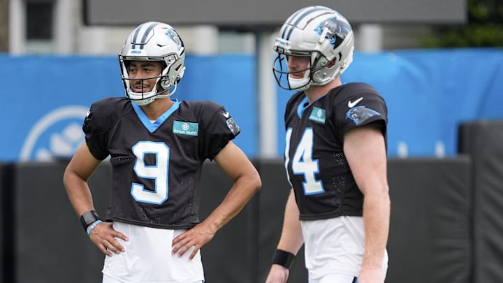 Jul 30, 2024; Charlotte, NC, USA;  Carolina Panthers quarterback Bryce Young (9) and quarterback Andy Dalton (14) talk during training camp at Carolina Panthers Practice Fields. Mandatory Credit: Jim Dedmon-USA TODAY Sports