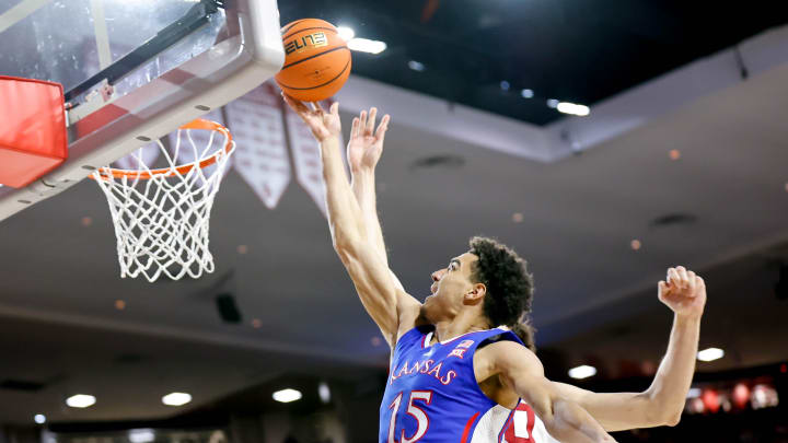Kansas guard Kevin McCullar Jr. (15) lays up the ball past Oklahoma forward Sam Godwin (10) in the first half during an NCAA basketball game between The University of Oklahoma (OU) and The University of Kansas (KU), at the Lloyd Noble Center in Norman Okla., on Saturday, Feb. 17, 2024. Kansas guard Kevin McCullar Jr. (15) lays up the ball past Oklahoma forward Sam Godwin (10) in the first half during an NCAA basketball game between The University of Oklahoma (OU) and The University of Kansas (KU), at the Lloyd Noble Center in Norman Okla., on Saturday, Feb. 17, 2024.