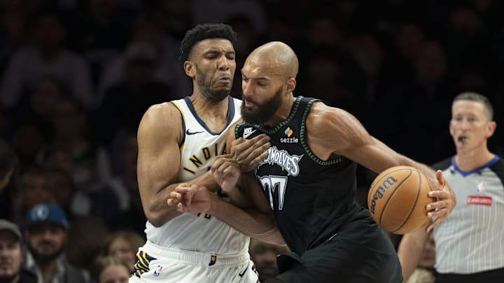 Oct 26, 2025; Minneapolis, Minnesota, USA; Minnesota Timberwolves center Rudy Gobert (27) dribbles the ball past Indiana Pacers center Tony Bradley (13) in the second half at Target Center. Mandatory Credit: Jesse Johnson-Imagn Images