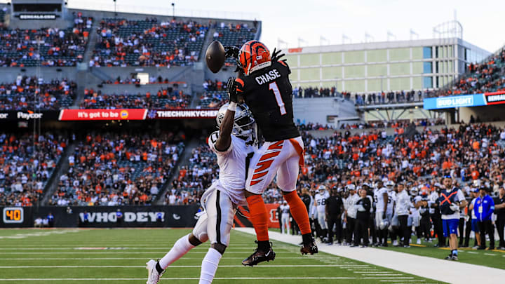 Nov 3, 2024; Cincinnati, Ohio, USA; Cincinnati Bengals wide receiver Ja'Marr Chase (1) attempts to catch a pass against Las Vegas Raiders cornerback Jakorian Bennett (0) in the second half at Paycor Stadium. Mandatory Credit: Katie Stratman-Imagn Images