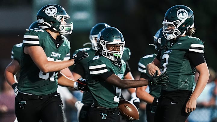Trinity's Brennen Lowe (5) celebrates his touchdown reception from a pass by Trinity quarterback Zane Johnson (3) in the first half during KHSAA Class 6A football Friday, August 29, 2025 at R.W. Marshall Stadium in Louisville, Kentucky.