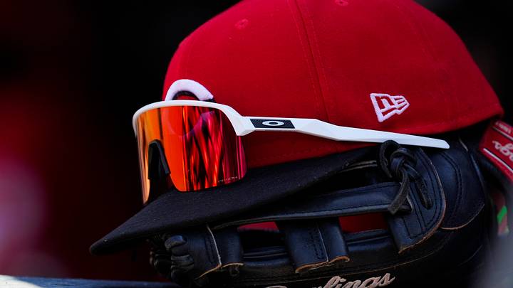Jul 19, 2026; Denver, Colorado, USA; Detailed view of a Cincinnati Reds cap and glove during the game against the Colorado Rockies at Coors Field. Mandatory Credit: Ron Chenoy-Imagn Images Jul 19, 2026; Denver, Colorado, USA; Detailed view of a Cincinnati Reds cap and glove during the game against the Colorado Rockies at Coors Field. Mandatory Credit: Ron Chenoy-Imagn Images