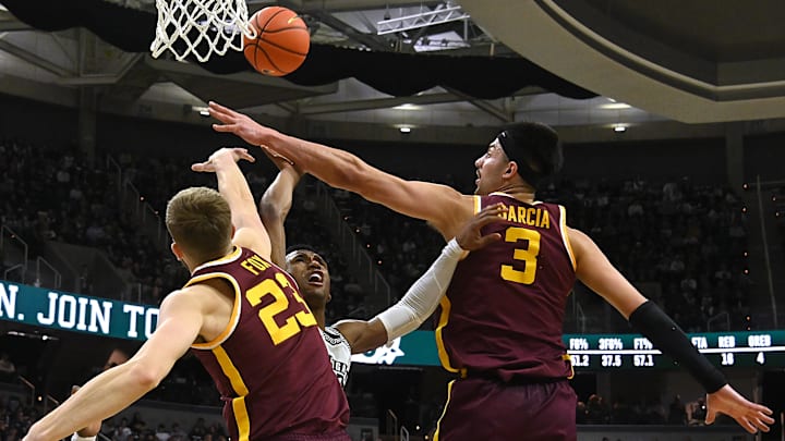 Jan 18, 2024; East Lansing, Michigan, USA; Michigan State Spartans guard Tyson Walker (2) gets blocked by Minnesota Golden Gophers forward Dawson Garcia (3) and forward Parker Fox (23) during the second half at Jack Breslin Student Events Center. Mandatory Credit: Dale Young-Imagn Images