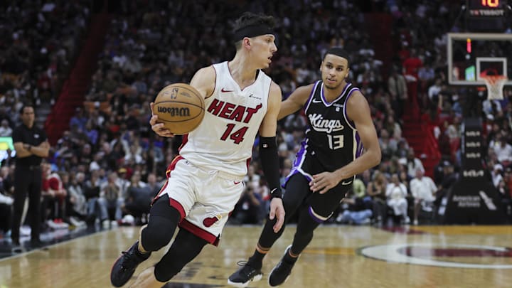 Jan 31, 2024; Miami, Florida, USA; Miami Heat guard Tyler Herro (14) dribbles the basketball against Sacramento Kings forward Keegan Murray (13) during the fourth quarter at Kaseya Center. Mandatory Credit: Sam Navarro-Imagn Images