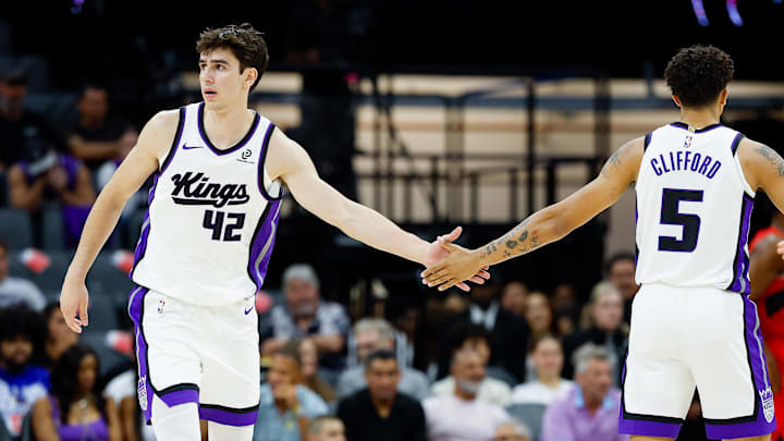Oct 8, 2025; Sacramento, California, USA; Sacramento Kings center Maxime Raynaud (42) shakes hands with guard Nique Clifford (5) during the fourth quarter against the Toronto Raptors at Golden 1 Center. Mandatory Credit: Sergio Estrada-Imagn Images