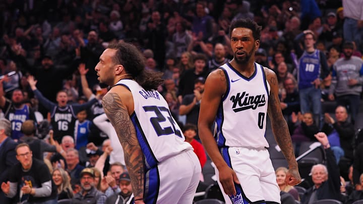 Mar 19, 2025; Sacramento, California, USA; Sacramento Kings guard Malik Monk (0) reacts towards guard Devin Carter (22) after Carter’s dunk against the Cleveland Cavaliers during the second quarter at Golden 1 Center. Mandatory Credit: Kelley L Cox-Imagn Images