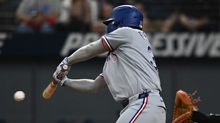 Sep 26, 2025; Cleveland, Ohio, USA; Texas Rangers second baseman Cody Freeman (39) hits an RBI single against the Cleveland Guardians during the seventh inning at Progressive Field. 