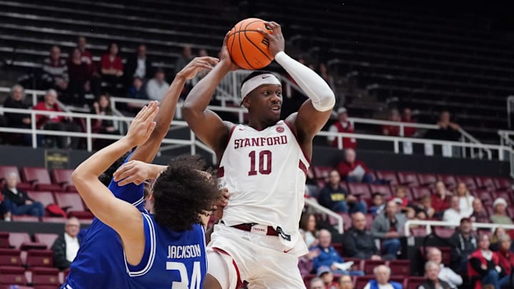 Dec 17, 2025; Stanford, California, USA;  Stanford Cardinal forward Chisom Okpara (10) looks to pass over Texas-Arlington Mavericks forward/center Cameron Jackson (34) in the first half at Maples Pavilion. Mandatory Credit: David Gonzales-Imagn Images