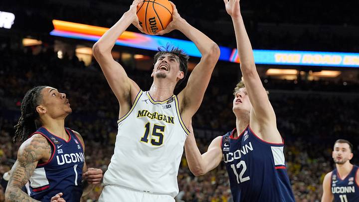Michigan center Aday Mara (15) looks for a basket around Connecticut guard Solo Ball (1) and center Eric Reibe Michigan center Aday Mara (15) looks for a basket around Connecticut guard Solo Ball (1) and center Eric Reibe
