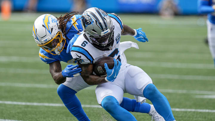 Sep 15, 2024; Charlotte, North Carolina, USA;  Carolina Panthers running back Miles Sanders (6) is tackled by Los Angeles Chargers cornerback Ja'Sir Taylor (36) during the second half at Bank of America Stadium. Mandatory Credit: Jim Dedmon-Imagn Images
