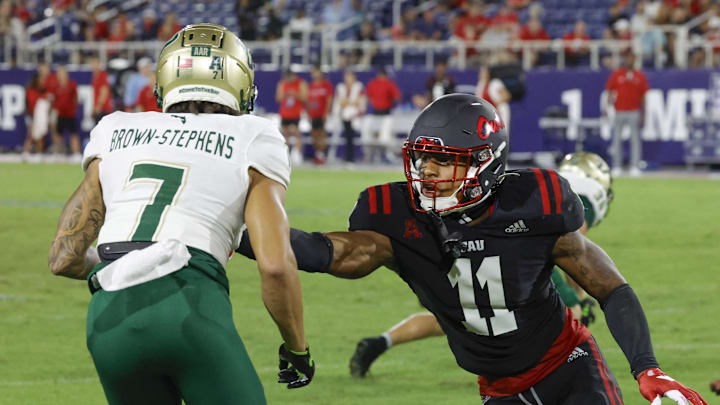 Nov 1, 2024; Boca Raton, Florida, USA;  South Florida Bulls wide receiver Michael Brown-Stephens (7) runs past Florida Atlantic Owls defensive back Kahzir Brown (11) during the second half at FAU Stadium. Credit: Reinhold Matay-Imagn Images