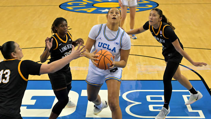 Dec 20, 2025; Los Angeles, California, USA; UCLA Bruins forward Sienna Betts (16) drives past Long Beach State Beach guard Jaquoia Jones-Brown (30), guard Khylee Pepe (13) and forward Kennan Ka (5) for a basket during the first half at Pauley Pavilion presented by Wescom Financial. Mandatory Credit: Jayne Kamin-Oncea-Imagn Images