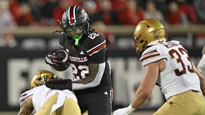 Oct 25, 2025; Louisville, Kentucky, USA; Louisville Cardinals running back Keyjuan Brown (22) runs the ball against Boston College Eagles defensive back Omar Thornton (0) and linebacker Owen McGowan (33) during the second half at L&N Federal Credit Union Stadium. Mandatory Credit: Jamie Rhodes-Imagn Images Oct 25, 2025; Louisville, Kentucky, USA; Louisville Cardinals running back Keyjuan Brown (22) runs the ball against Boston College Eagles defensive back Omar Thornton (0) and linebacker Owen McGowan (33) during the second half at L&N Federal Credit Union Stadium. Mandatory Credit: Jamie Rhodes-Imagn Images
