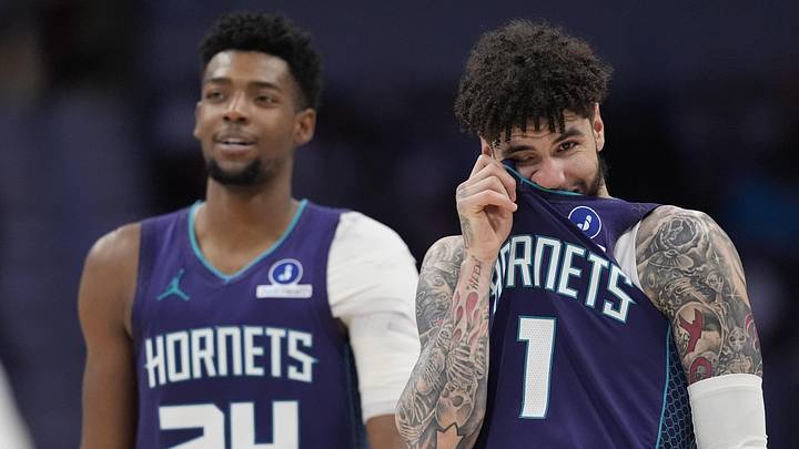 Charlotte Hornets guard LaMelo Ball (1) and forward Brandon Miller (24) watch a free throw 