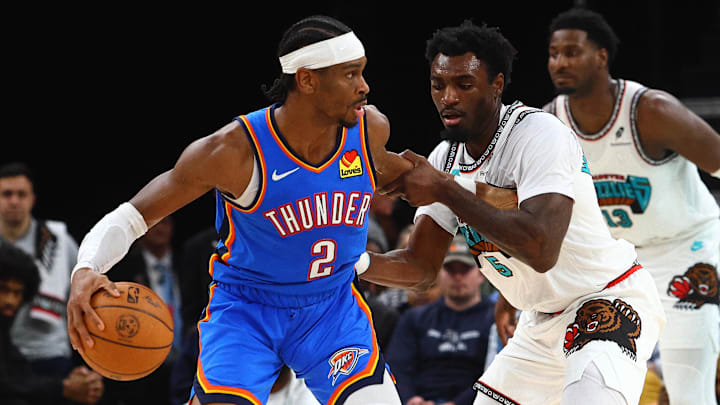 Feb 8, 2025; Memphis, Tennessee, USA; Oklahoma City Thunder guard Shai Gilgeous-Alexander (2) dribbles as Memphis Grizzlies guard Vince Williams Jr. (5) defends during the third quarter at FedExForum. Mandatory Credit: Petre Thomas-Imagn Images