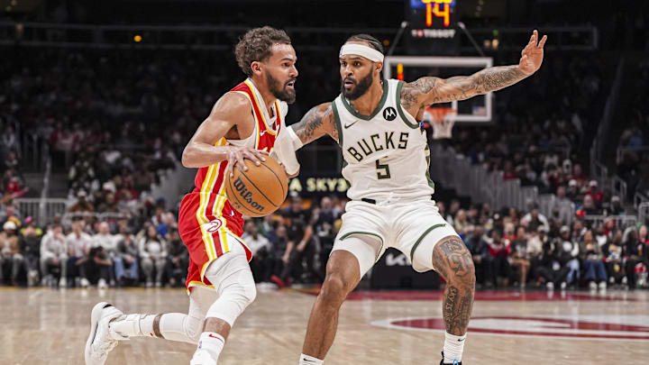 Mar 4, 2025; Atlanta, Georgia, USA; Atlanta Hawks guard Trae Young (11) dribbles against Milwaukee Bucks guard Gary Trent Jr. (5) during the second half at State Farm Arena. Mandatory Credit: Dale Zanine-Imagn Images