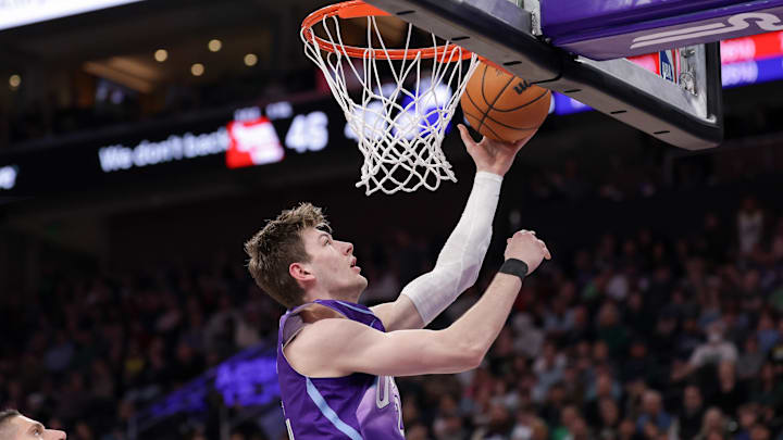 Mar 17, 2025; Salt Lake City, Utah, USA;  Utah Jazz forward Kyle Filipowski (22) lays the ball into the basket during the second quarter against the Chicago Bulls at Delta Center. Mandatory Credit: Chris Nicoll-Imagn Images