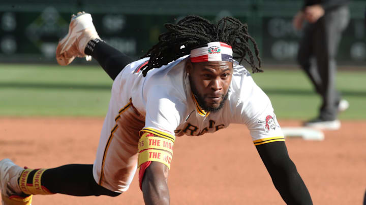 May 24, 2025; Pittsburgh, Pennsylvania, USA;  Pittsburgh Pirates center fielder Oneil Cruz (15) dives into third base with an RBI triple against the Milwaukee Brewers during the seventh inning at PNC Park. Mandatory Credit: Charles LeClaire-Imagn Images