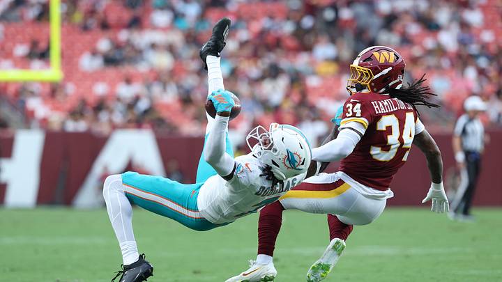 Aug 14, 2026; Landover, Maryland, USA; Miami Dolphins wide receiver Caleb Douglas (7) reaches for a pass as Washington Commanders cornerback Antonio Hamilton Sr. (34) defends during the first half at Northwest Stadium. Mandatory Credit: Amber Searls-Imagn Images Aug 14, 2026; Landover, Maryland, USA; Miami Dolphins wide receiver Caleb Douglas (7) reaches for a pass as Washington Commanders cornerback Antonio Hamilton Sr. (34) defends during the first half at Northwest Stadium. Mandatory Credit: Amber Searls-Imagn Images