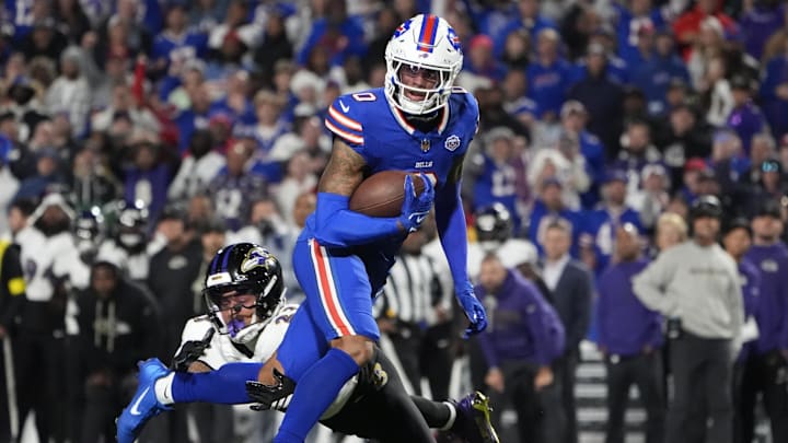 Buffalo Bills wide receiver Keon Coleman (0) runs the ball against Baltimore Ravens cornerback Jaire Alexander (23) during the fourth quarter at Highmark Stadium.