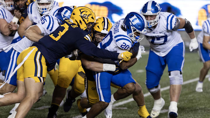 Duke running back Nate Sheppard (20)  drags two Cal defenders. 