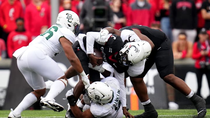 Cincinnati Bearcats quarterback Emory Jones (5) is sacked by Baylor Bears defensive lineman TJ Franklin (9) in the second quarter during a college football game between the Baylor Bears and the Cincinnati Bearcats, Saturday, Oct. 21, 2023, at Nippert Stadium in Cincinnati. Cincinnati Bearcats quarterback Emory Jones (5) is sacked by Baylor Bears defensive lineman TJ Franklin (9) in the second quarter during a college football game between the Baylor Bears and the Cincinnati Bearcats, Saturday, Oct. 21, 2023, at Nippert Stadium in Cincinnati.