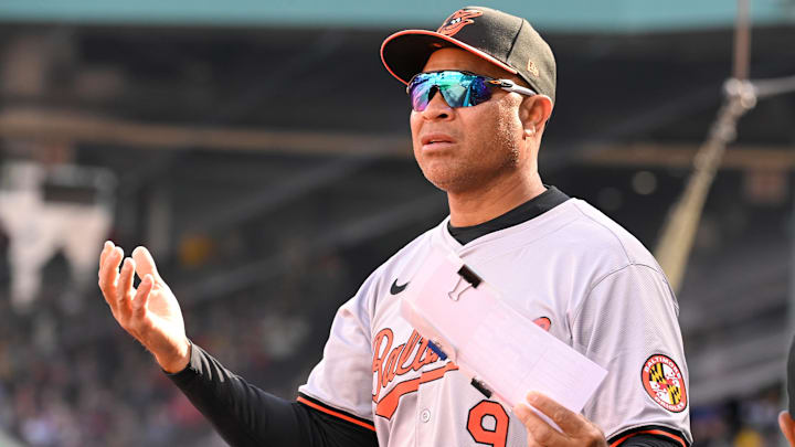 Apr 9, 2024; Boston, Massachusetts, USA; Baltimore Orioles first base coach Anthony Sanders (9) signals to the outfield during the fifth inning against the Boston Red Sox at Fenway Park. Mandatory Credit: Eric Canha-Imagn Images