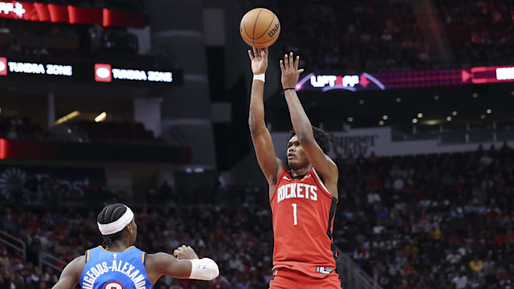 Dec 1, 2024; Houston, Texas, USA; Houston Rockets forward Amen Thompson (1) shoots the ball as Oklahoma City Thunder guard Shai Gilgeous-Alexander (2) defends during the game at Toyota Center. Mandatory Credit: Troy Taormina-Imagn Images