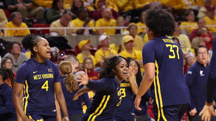 Jan 11, 2026; Ames, Iowa, USA; West Virginia Mountaineers forward Celia Riviere (37) celebrates with teammates against the Iowa State Cyclones during the second half at James H. Hilton Coliseum. Mandatory Credit: Reese Strickland-Imagn Images